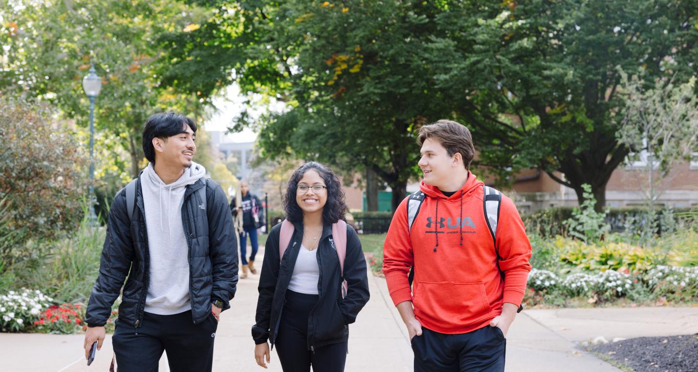 Three students walking on campus