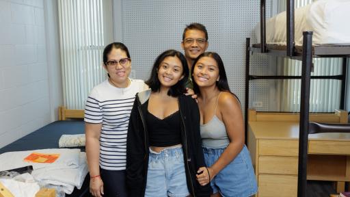 A family moving into a dorm room