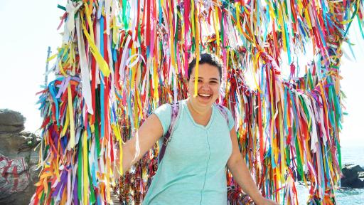 Student surrounded by colorful ribbons